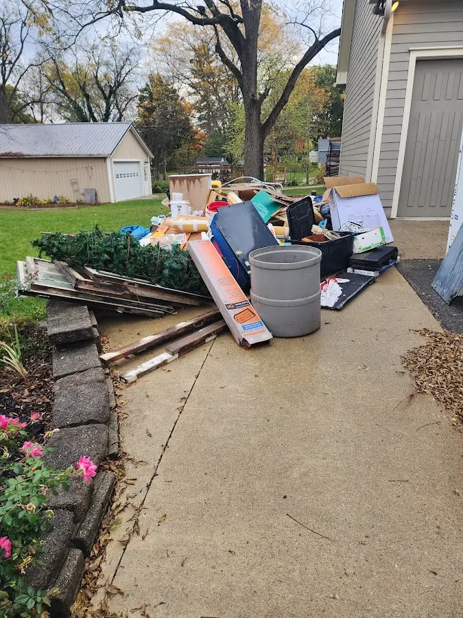 Dumpster being loaded with debris for 12 Yard Dumpster Rental in Beech Grove